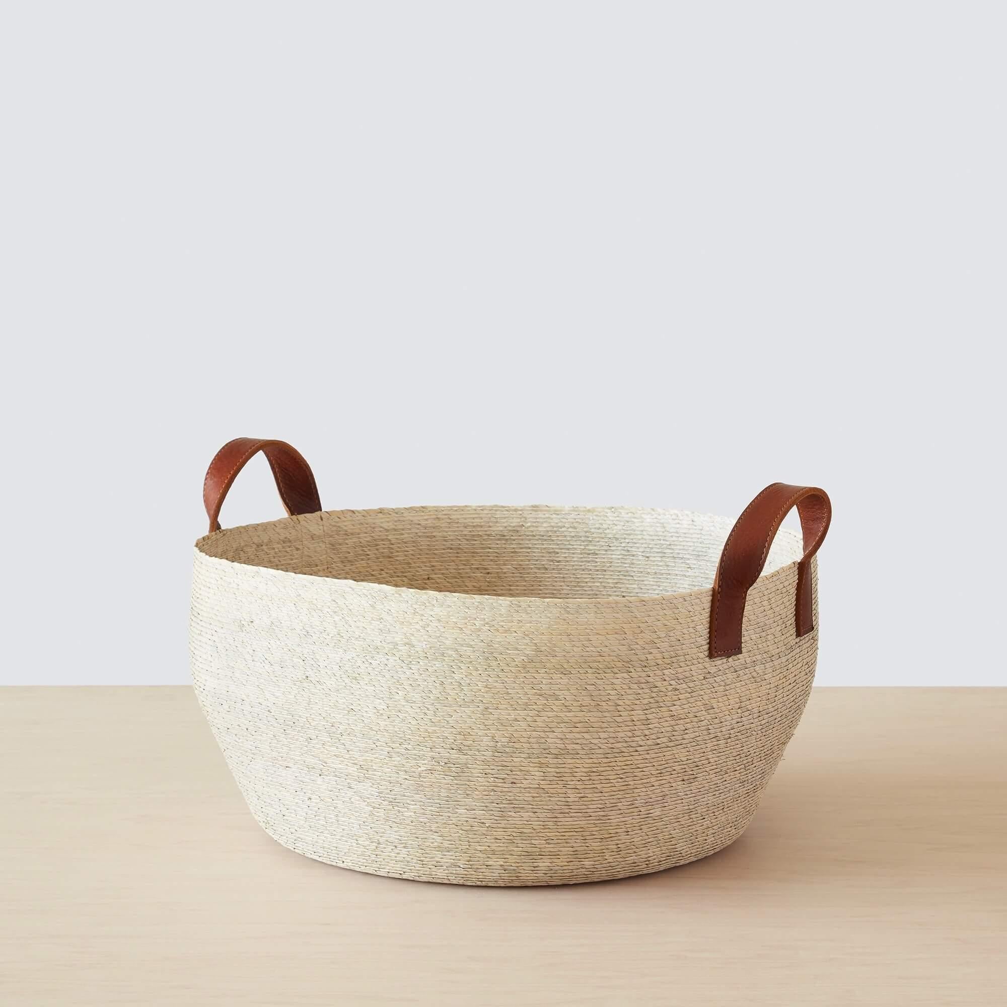 Medium handwoven palm storage basket with leather handles, natural
