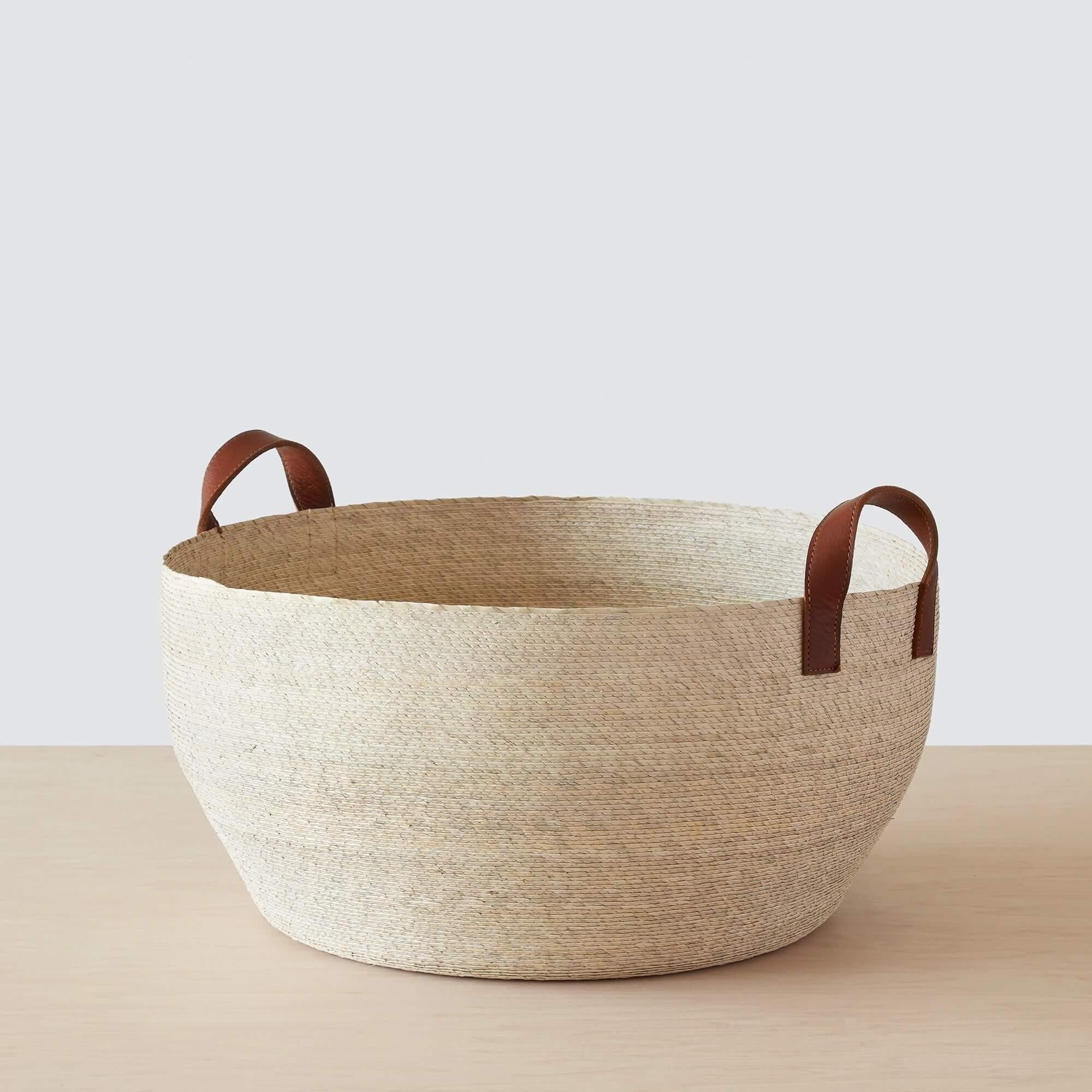 Large handwoven palm storage basket with leather handles, natural
