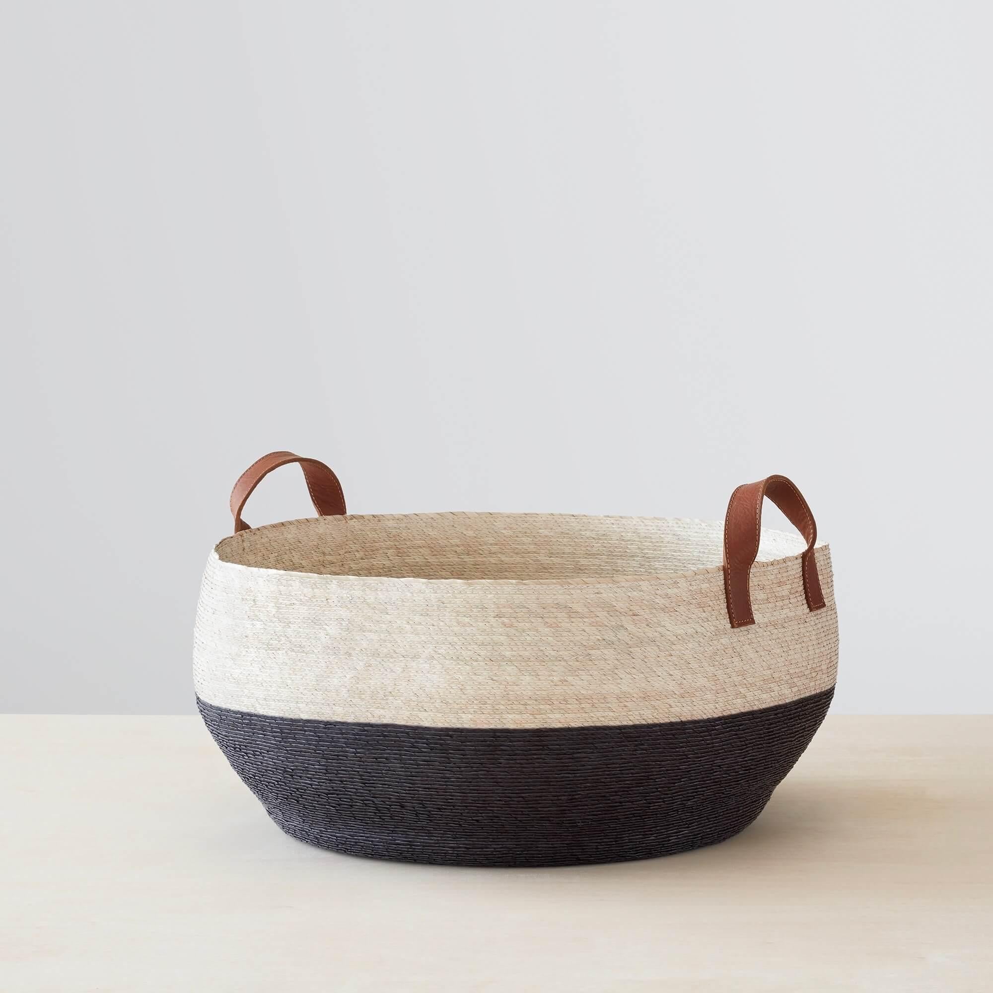 Black and natural color-blocked woven storage basket with leather handles, black