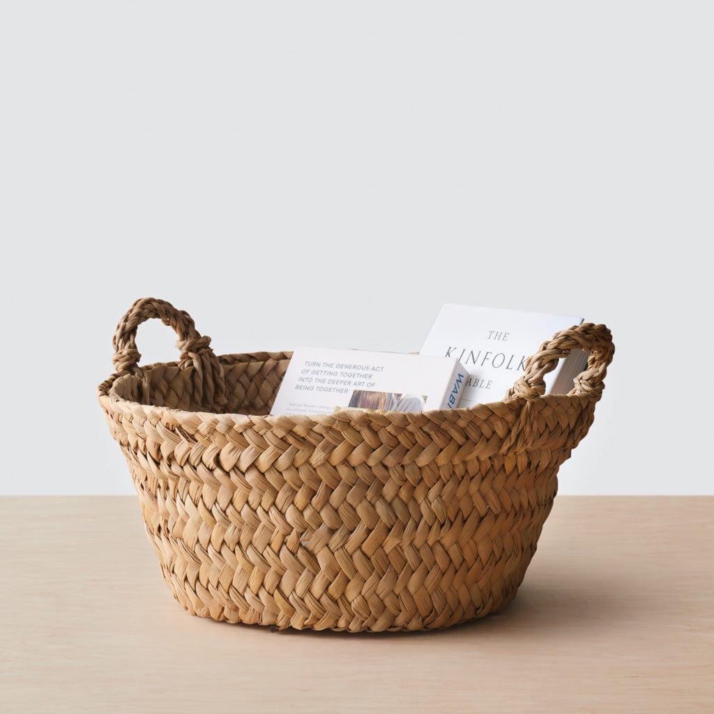 Books in woven floor basket
